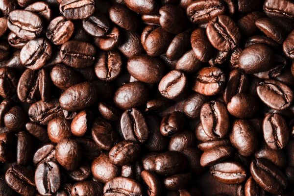 a pile of coffee beans sitting on top of a wooden table