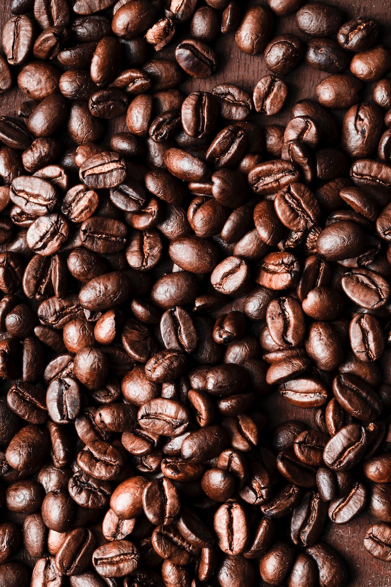 a pile of coffee beans sitting on top of a wooden table