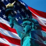 statue of liberty with american flag